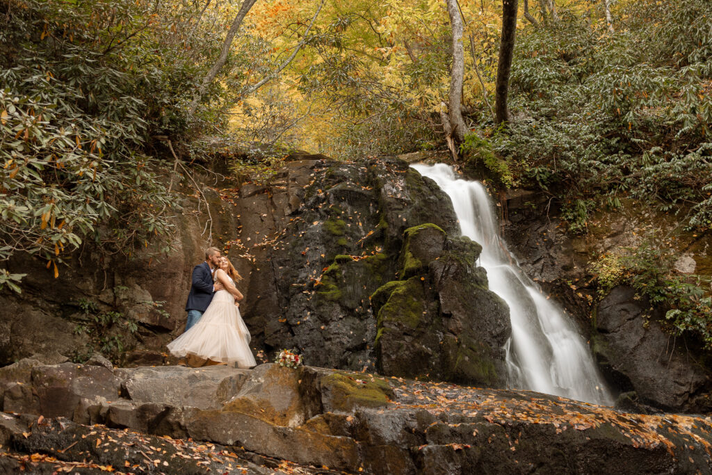 Couple's first dance on a waterfall ledge during elopement