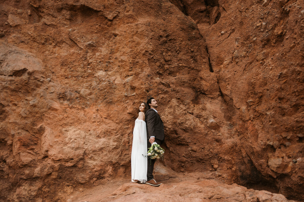 Couple eloping in Arizona, standing back to back