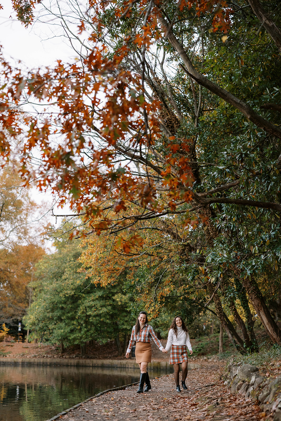 Piedmont Park photoshoot with two lesbian women walking toward the camera in the fall colors.