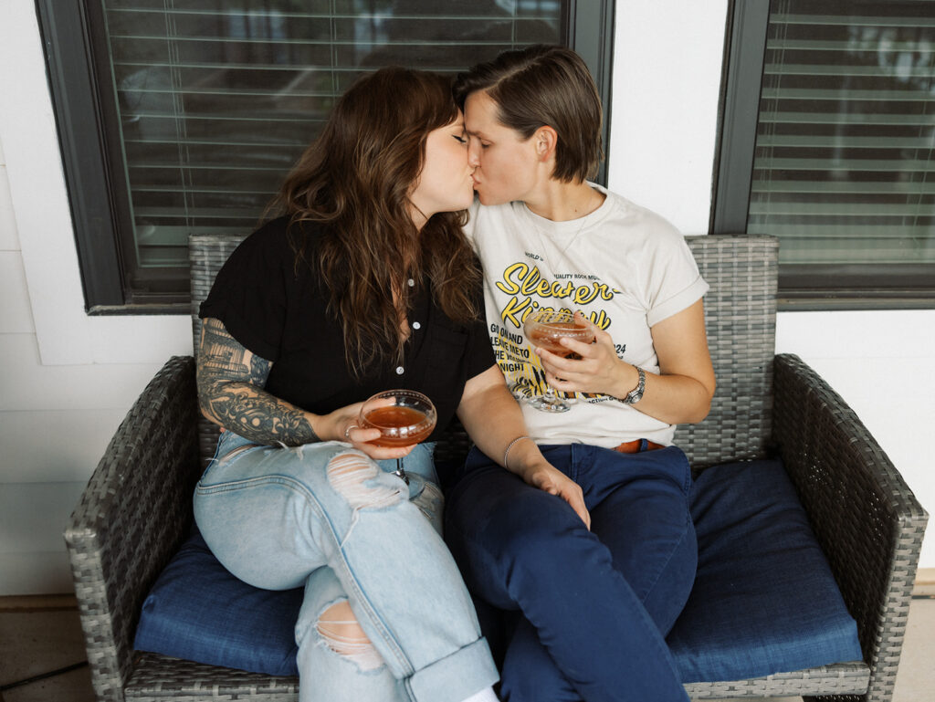 Couple sitting on couch kissing during a Couples Photography Session in Atlanta, GA