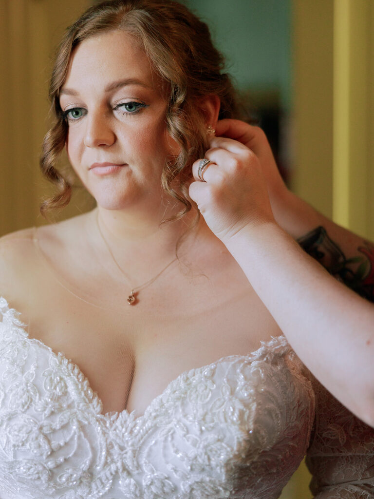 Taylor-Grady House wedding preparations with mom putting earrings on bride