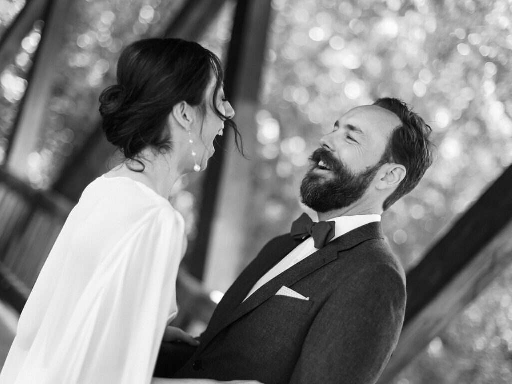 Couple laughing during their first look at their Roswell Mill wedding