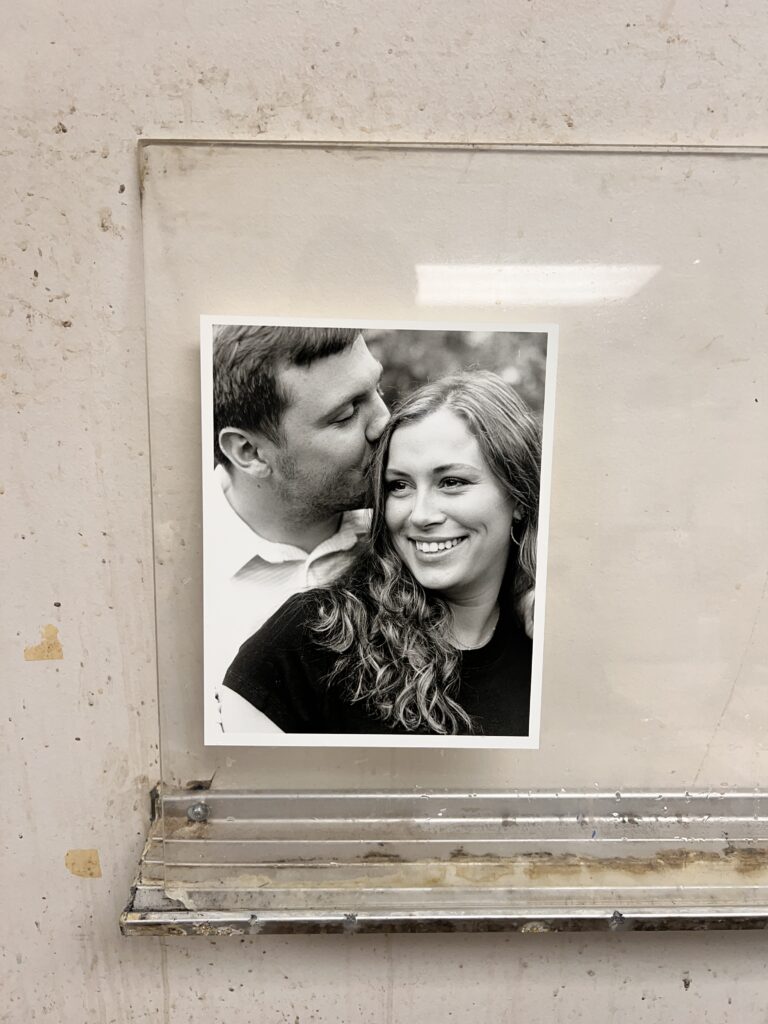 Dark room couple's session print displayed on the wall