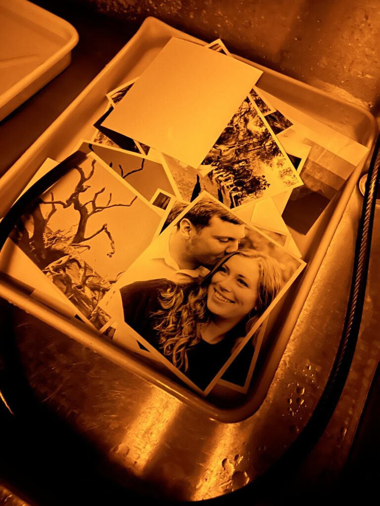 Dark room couple's session image in the wash bin of a dark room