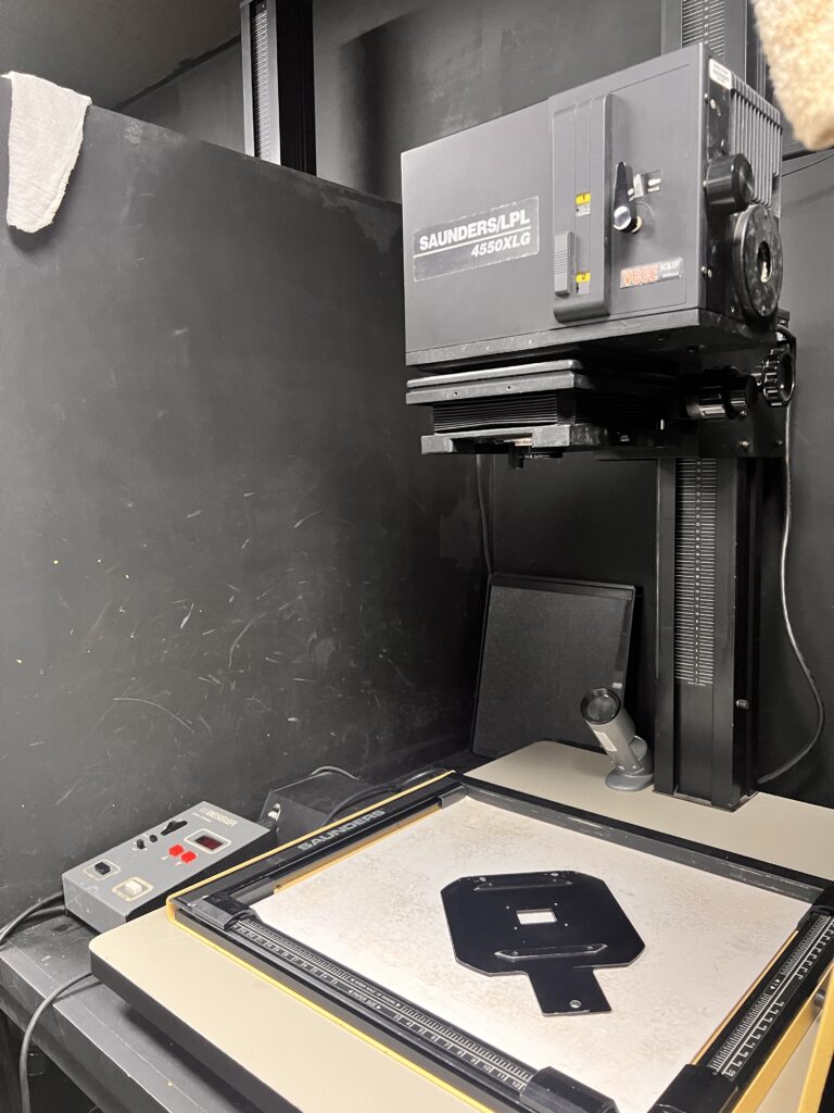 Enlarger being prepped for use for developing during a dark room couple's session